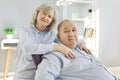 Happy senior family couple wife and husband sitting on sofa in the living room at home. Royalty Free Stock Photo