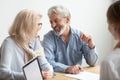 Happy senior family talking smiling at meeting with financial ad