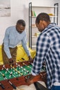 happy senior father and adult son playing table football Royalty Free Stock Photo