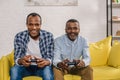 happy senior father and adult son using joysticks and smiling Royalty Free Stock Photo