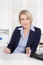 Happy senior female manager - portrait in the office. Royalty Free Stock Photo