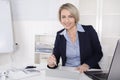 Happy senior female manager - portrait in the office. Royalty Free Stock Photo