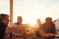 Happy senior friends dining and drinking red wine on house terrace - Mature people having fun cheering together at dinner party Royalty Free Stock Photo