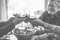 Happy senior friends having fun cheering with red wine - Mature people eating at dinner and laughing together - Black and white Royalty Free Stock Photo