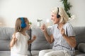 Happy Grandmother And Granddaughter Listening To Music In Headph
