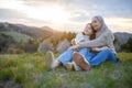 Happy senior grandmother with teenage granddaguhter hugging in nature on spring day. Royalty Free Stock Photo