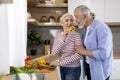 Happy Senior Husband And Wife Cooking Lunch And Having Fun In Kitchen Royalty Free Stock Photo