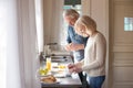 Happy senior couple make healthy breakfast on home kitchen