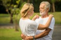 Happy senior loving couple relaxing at park embracing together in morning time. old people  hugging and enjoying spending time . Royalty Free Stock Photo