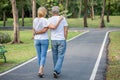 Happy senior loving couple relaxing at park embracing and walking together in morning time. old people hugging and enjoying