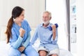 happy senior male patient health check and takecare by young female doctor or nurse at home after retirement for good health Royalty Free Stock Photo