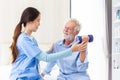 happy senior male patient health check and takecare by young female doctor or nurse at home after retirement for good health Royalty Free Stock Photo