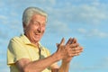 Happy senior man against blue cloudy sky Royalty Free Stock Photo