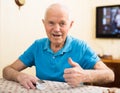 Happy senior man checking blood oxygen level with pulse oximeter Royalty Free Stock Photo