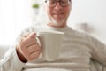 Happy senior man with cup of tea or coffee at home Royalty Free Stock Photo