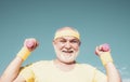 Happy senior man with dumbbell looking at camera. Health club or rehabilitation center for elderly aged pensioner Royalty Free Stock Photo