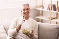 Happy senior man eating fresh vegetable salad Royalty Free Stock Photo