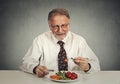Happy senior man eating fresh vegetable salad Royalty Free Stock Photo