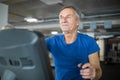 Happy senior man exercising on stair stepper at gym Royalty Free Stock Photo