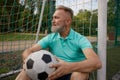 Happy senior man feeling tired after football training on soccer field Royalty Free Stock Photo