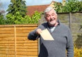 Happy senior man giving a plain brown envelope. Royalty Free Stock Photo
