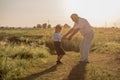 Happy senior man Grandfather with cute little boy grandson playing in field Royalty Free Stock Photo