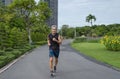 Happy senior man with grey hair in sportswear running  in the city park Royalty Free Stock Photo