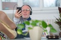 Senior man in headphones listening to music at home Royalty Free Stock Photo