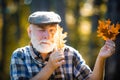 Happy senior man hiking in autumn in nature. Autumn portrait of grandfather. Autumn and active holidays. Happy senior Royalty Free Stock Photo