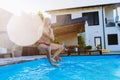 Happy senior man jumping into the swimming pool at backyard. Royalty Free Stock Photo