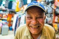 Happy senior man portrait in city shop