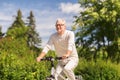 Happy senior man riding bicycle at summer park Royalty Free Stock Photo