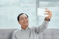 Happy Senior man Showing Toothy Smile While Taking Selfie Photo Using Mobile Phone Royalty Free Stock Photo