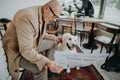 Happy senior man sitting in cafeteria and reading newspaper with his dog. Royalty Free Stock Photo