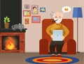 Happy senior man sitting on the sofa read book on tablet