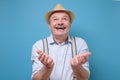 Happy senior man in summer hat asking for god mercy