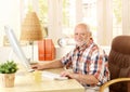 Happy senior man using computer Royalty Free Stock Photo