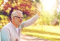 Happy senior man waving hand at summer park Royalty Free Stock Photo