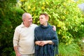 Happy senior man and woman hugged, enjoying beautiful sunny day outside together.