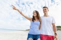 Happy young man and woman couple together walking on a beach Royalty Free Stock Photo