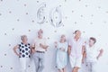 Happy senior man and woman holding silver balloons. Royalty Free Stock Photo