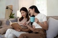 Happy senior mother with adult daughter sitting on couch and holding cups with coffee or tea at home. Enjoy family Royalty Free Stock Photo