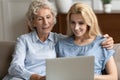 Happy senior mother and adult daughter using laptop Royalty Free Stock Photo