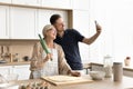 Happy senior mother and adult son taking cooking selfie Royalty Free Stock Photo