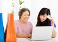 Happy senior Mother and daughter with laptop and credit card Royalty Free Stock Photo