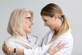 Happy senior mother embracing adult daughter laughing having fun Royalty Free Stock Photo