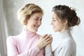 Happy senior mother embracing adult daughter laughing together, smiling excited aged older lady hugging young woman Royalty Free Stock Photo