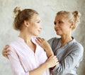 Happy senior mother embracing adult daughter laughing together, smiling excited aged older lady hugging young woman Royalty Free Stock Photo