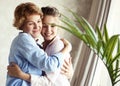 Happy senior mother embracing adult daughter laughing together, smiling excited aged older lady hugging young woman Royalty Free Stock Photo