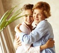 Happy senior mother embracing adult daughter laughing together, smiling excited aged older lady hugging young woman Royalty Free Stock Photo